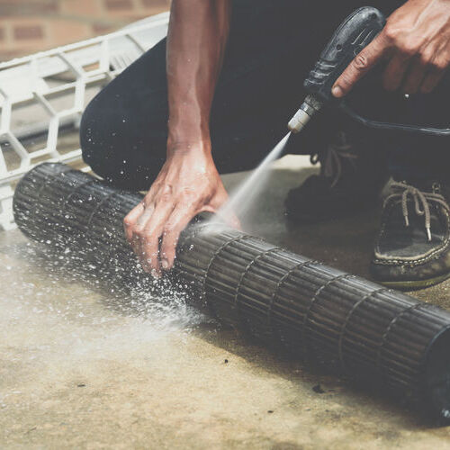 Worker to cleaning coil cooler of air conditioner. 